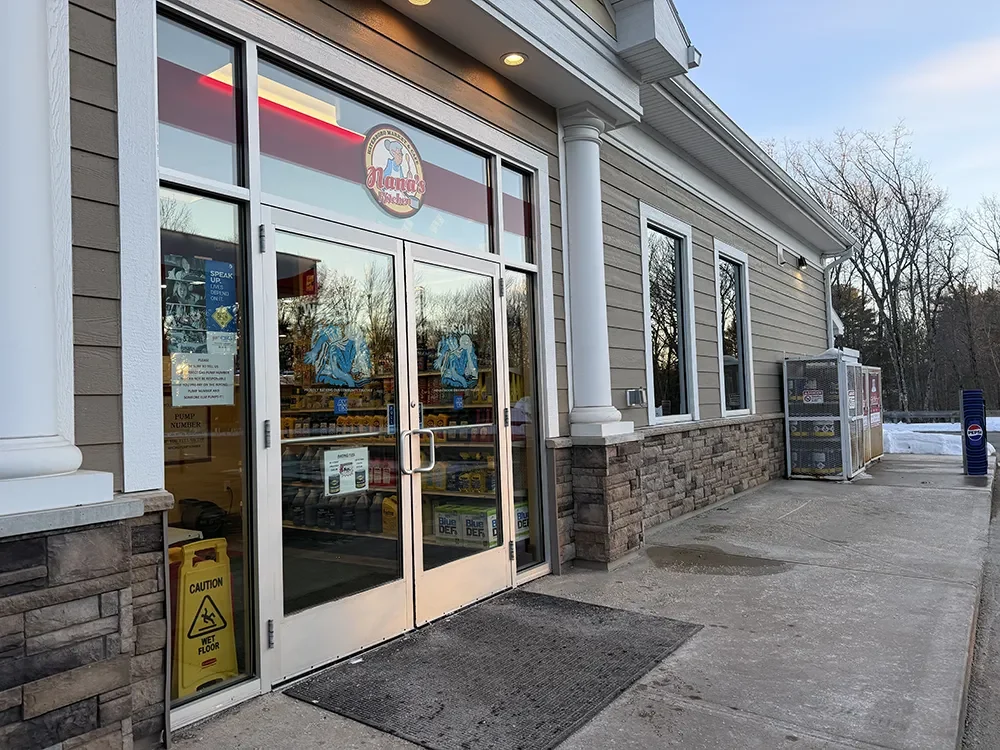A shop entrance with glass doors and side lights cleaned