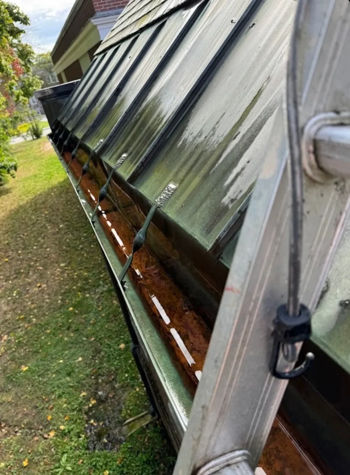 The same gutter run cleared by hand and flushed clean