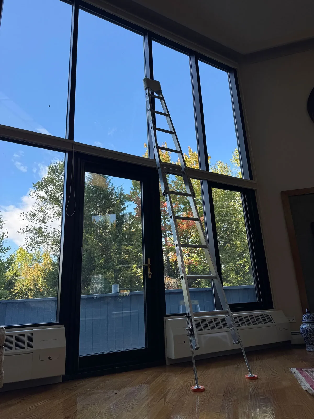 A two-story interior window wall with a ladder set on padding