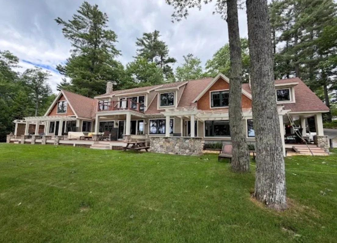 A large lakeside home with rows of windows cleaned inside and out