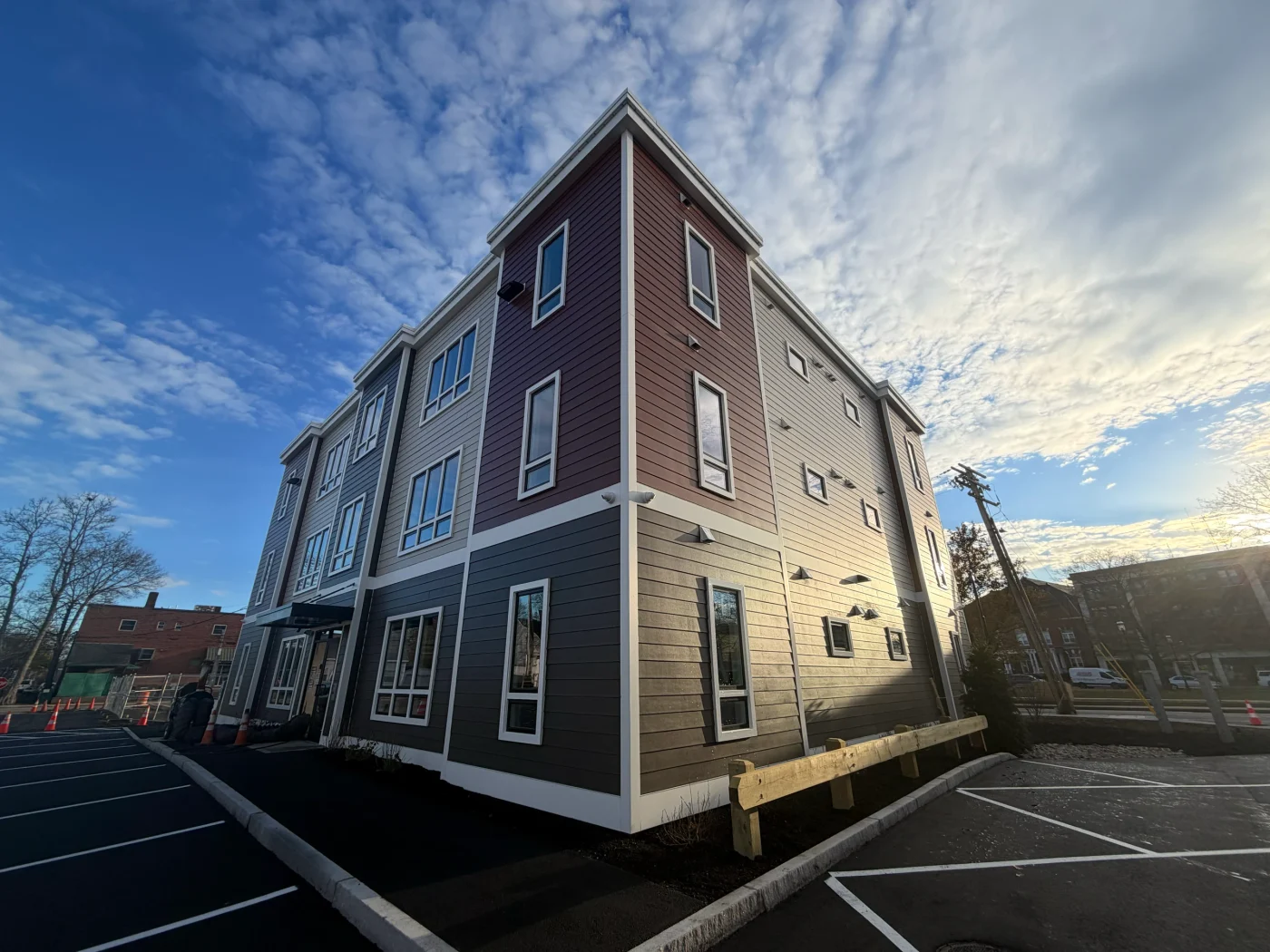 A newly built three-story multi-unit building with clean windows