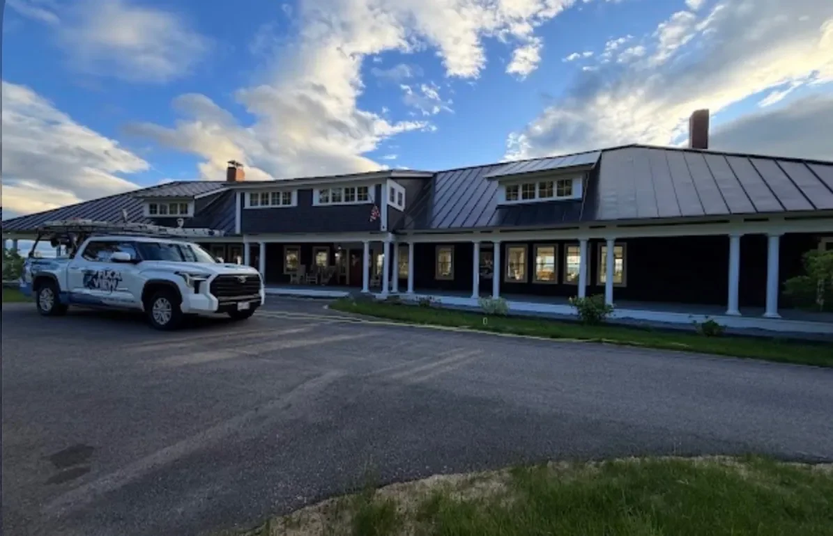 The Fix A View truck parked at a long shingled property in evening light