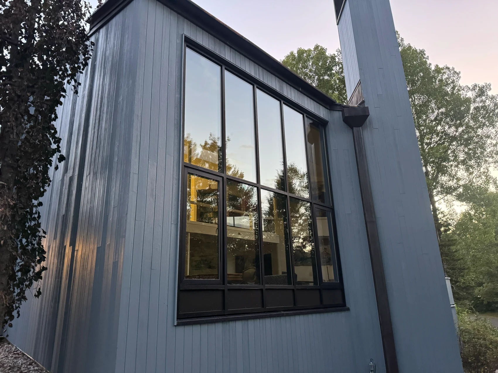 A tall gable window wall on a modern Maine home, cleaned inside and out